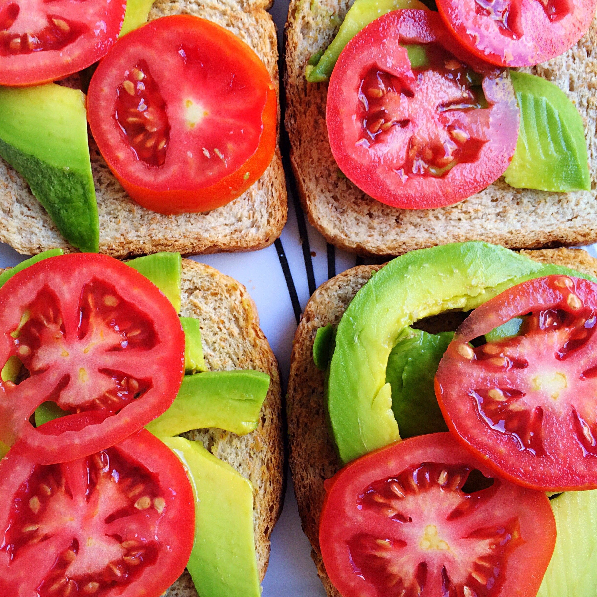 4 pieces of toast with avocado and tomato