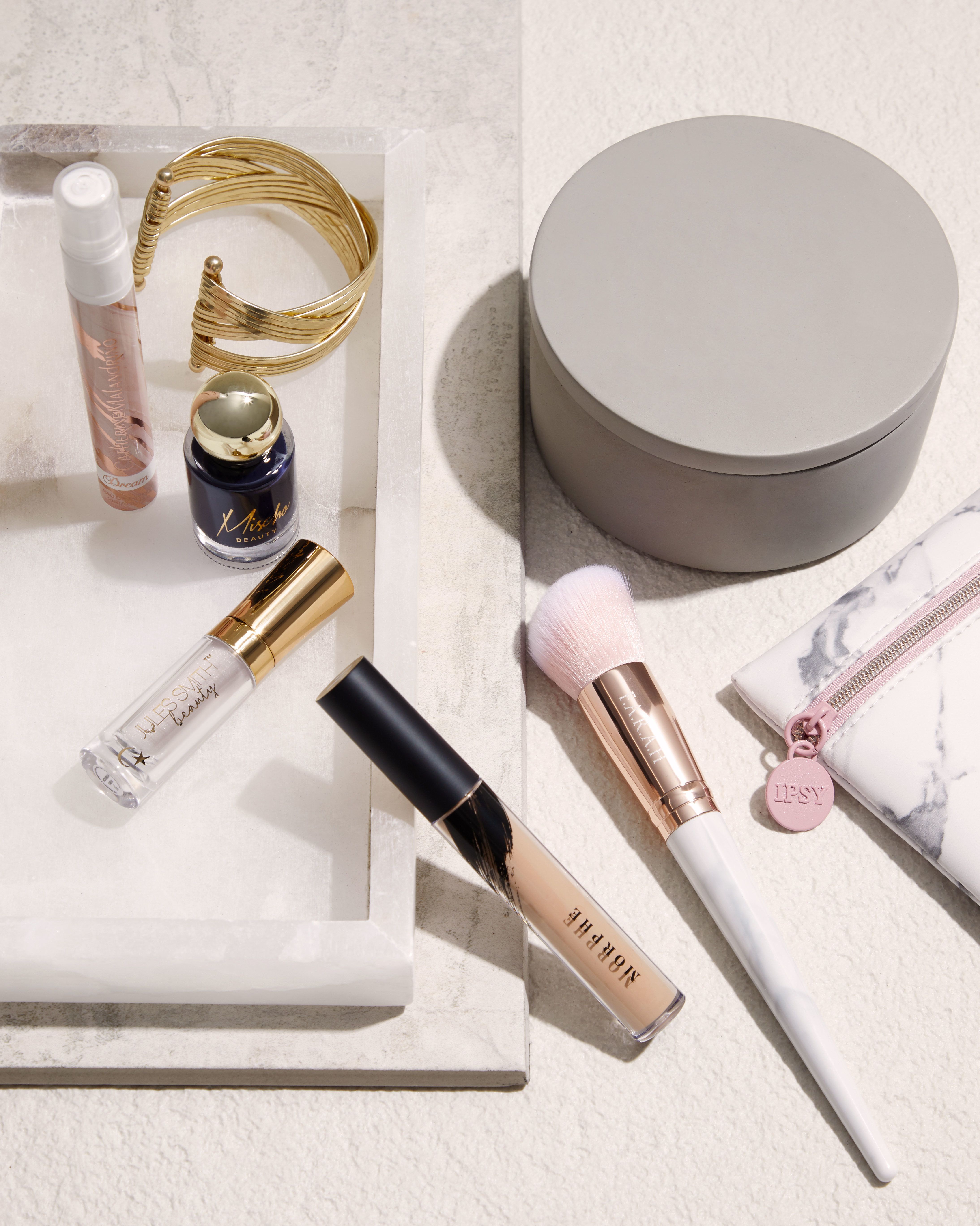 a few different branded make up pieces on a bathroom counter 