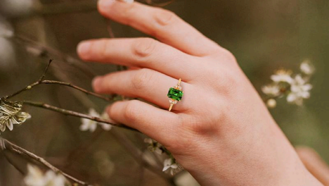 gold ring with emerald may birthstone ring by gemsny on woman's finger